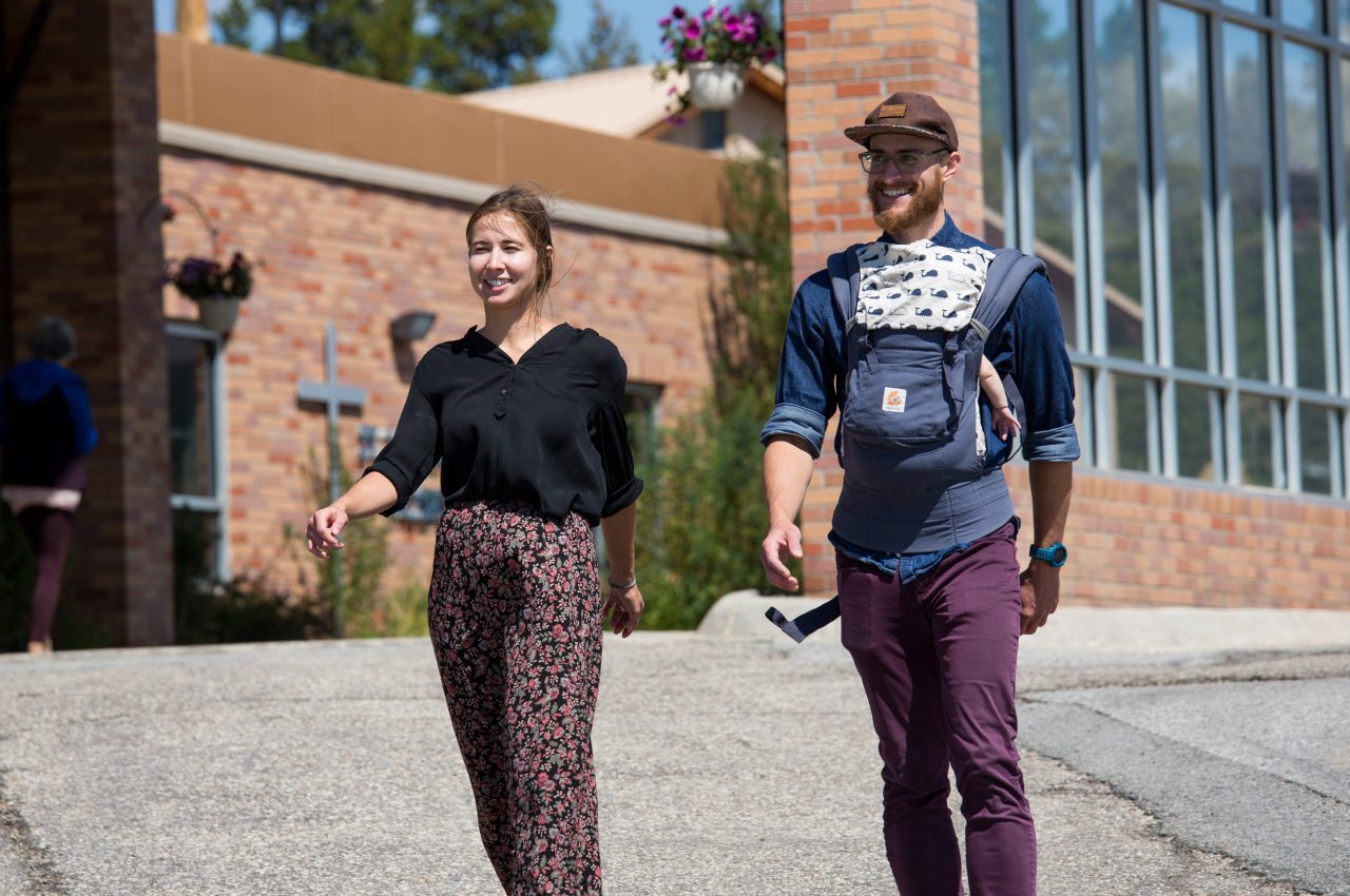 Mara Gwin and Noah Sosin, from Lake County Build a Generation have a "walk and talk" meeting while Noah's baby sleeps in Leadville, Colorado.  Gwin is the Organizational and Resource Development AmeriCorps VISTA and Sosin is the Resilient Lake County Manager, who works with residents of manufactured home communities to foster civic engagement and empower the residents to advocate for their rights as tenants.
