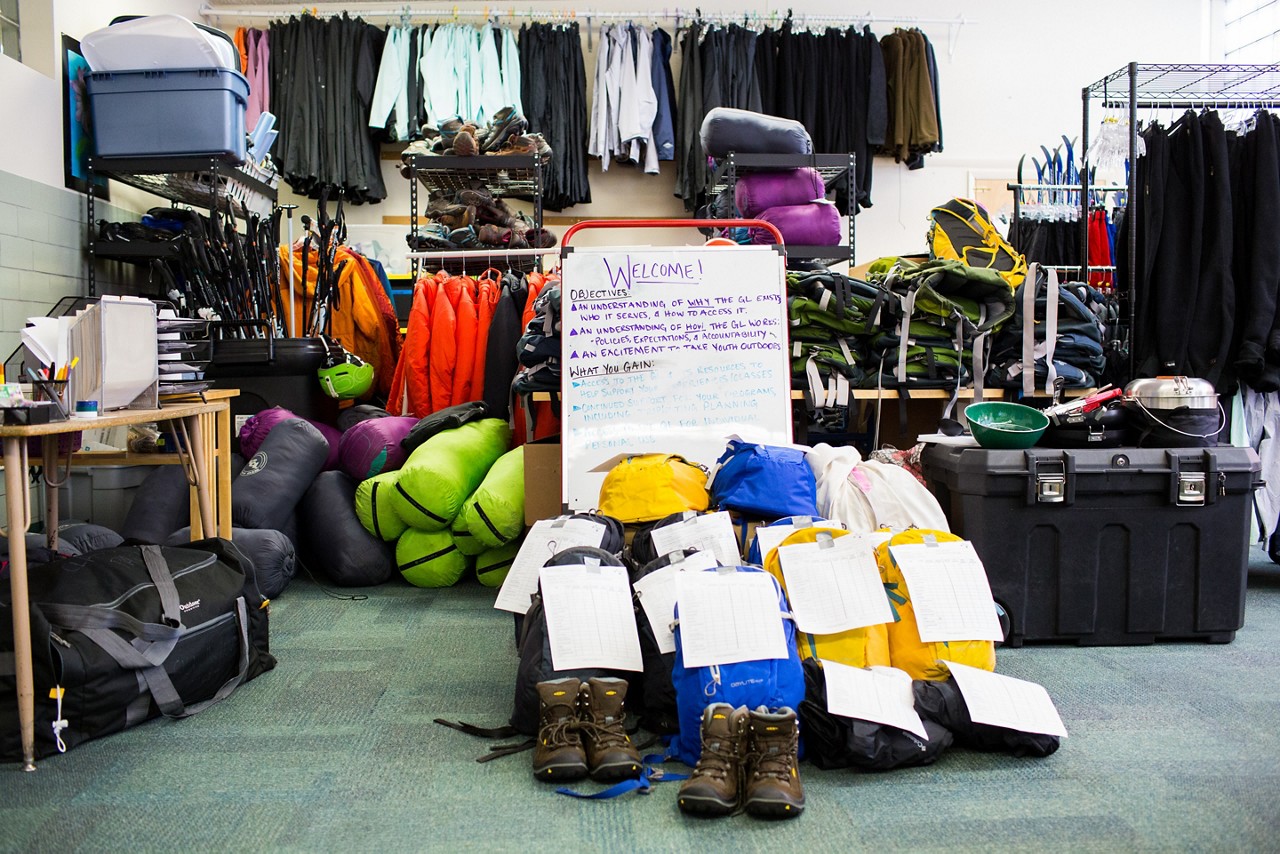 A neat pile of tagged camping gear available to rent.