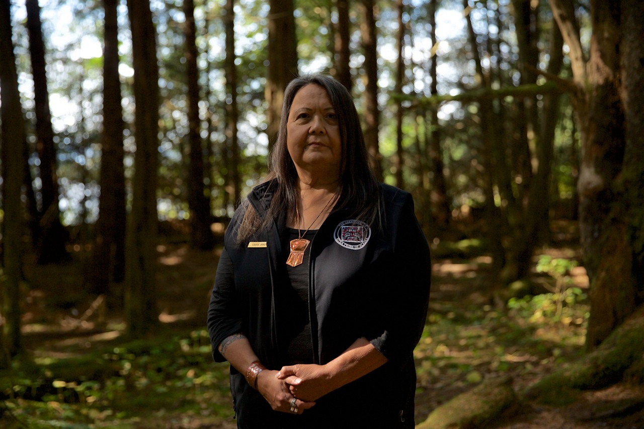 A woman standing in the woods.