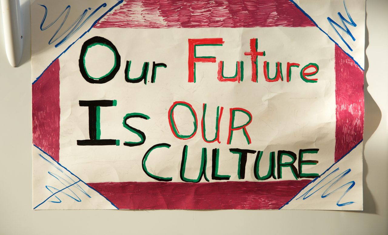 A handmade sign reads, "Our Future Is Our Culture."