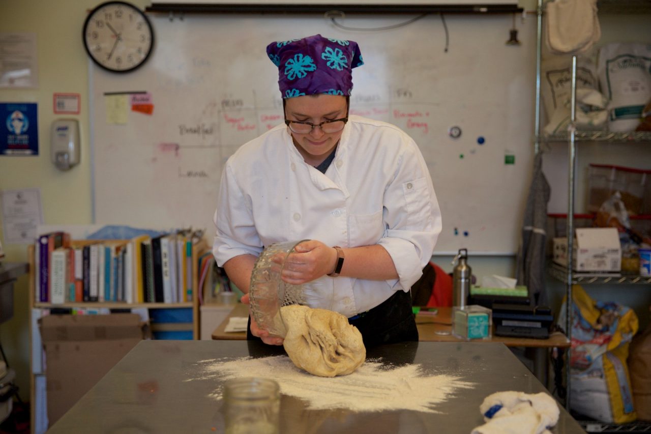 SITKA, ALASKA - SEPTEMBER 2019: Emma Spencer, an Americorp VISTA, preparing lunch at Southeast Alaska Career Center for students of Pacific High School.