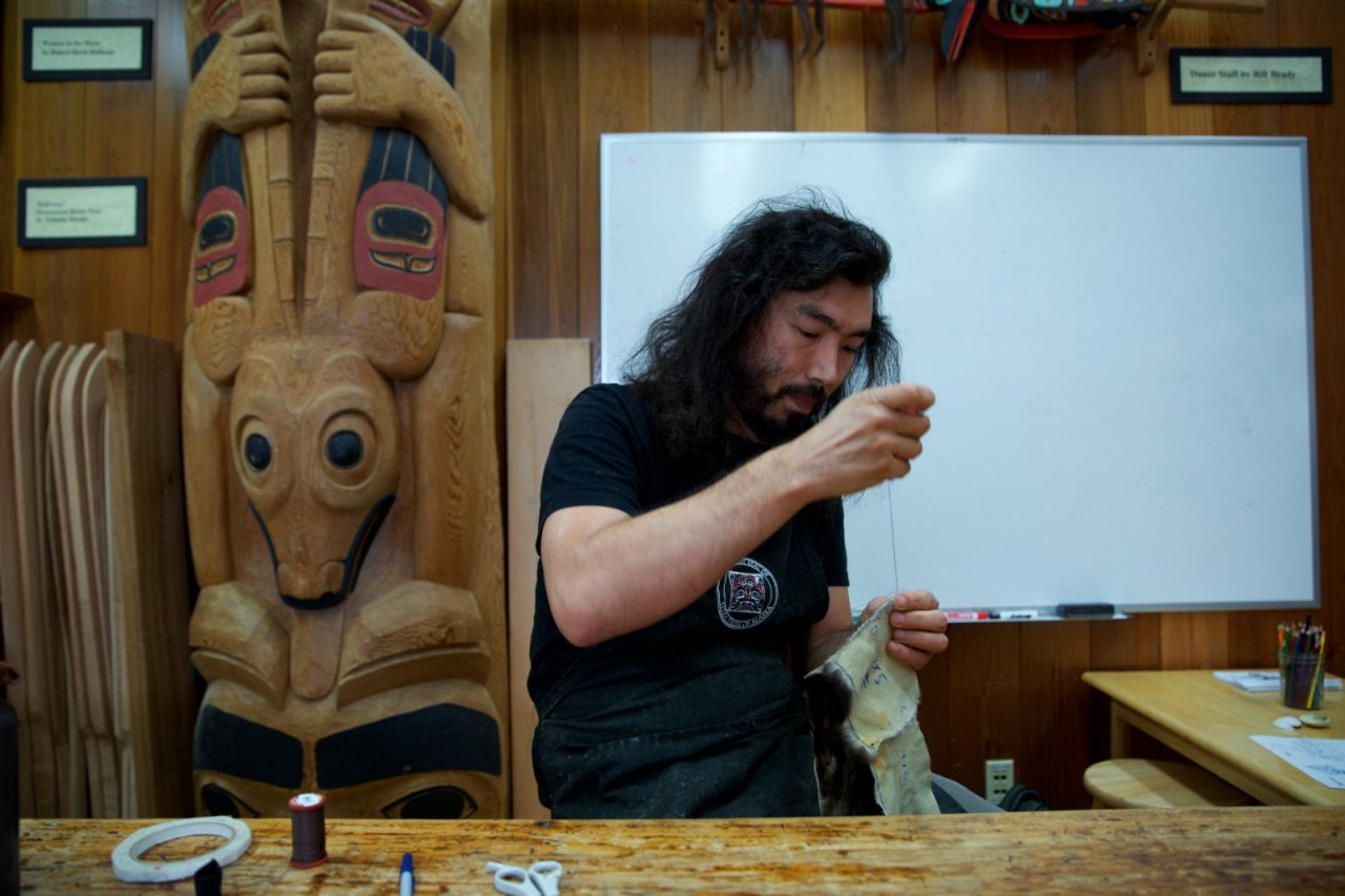 Artist Peter Williams working at the Sitka National Historical Park visitor center.