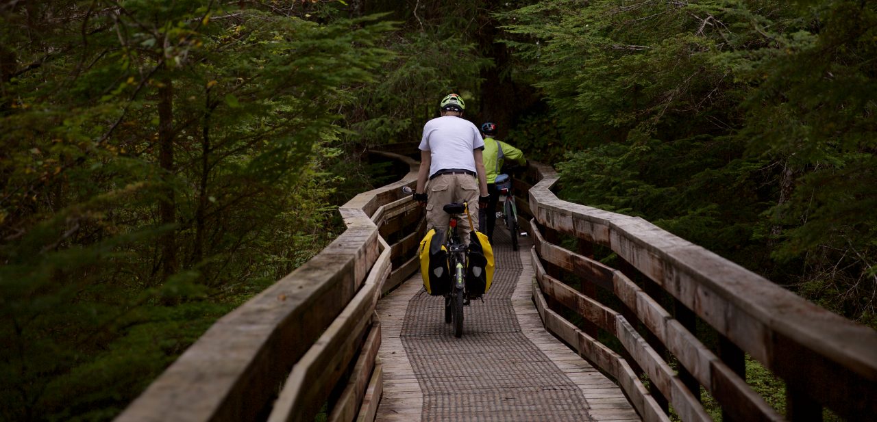 SITKA, ALASKA - SEPTEMBER 2019: Bicyclists using the Cross Trail located in Sitka, Alaska.