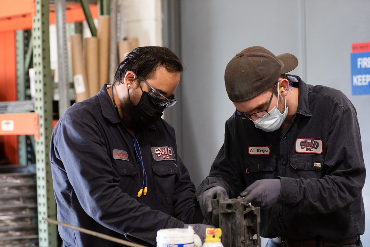 Two men engage in job training activities.