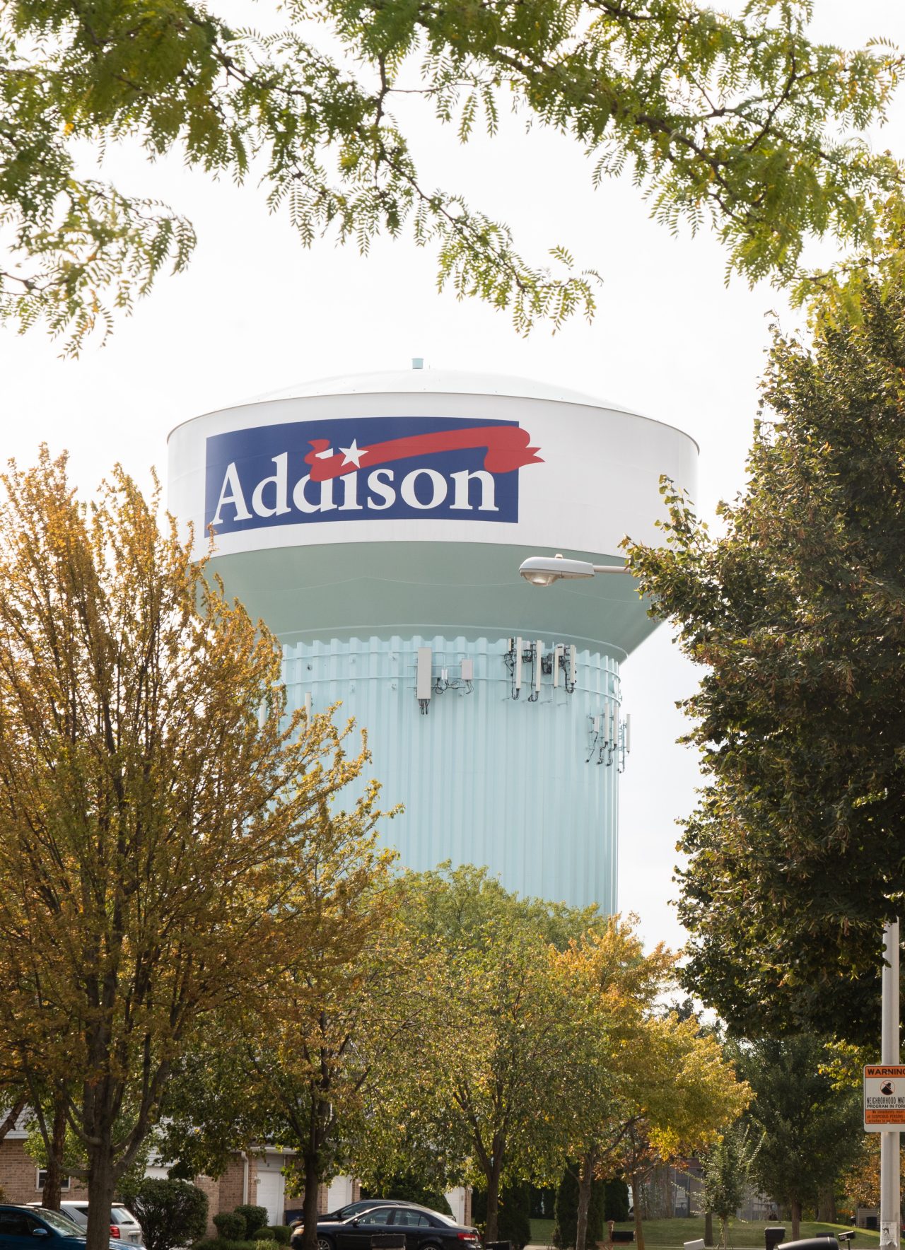 A water tower can be seen among trees.