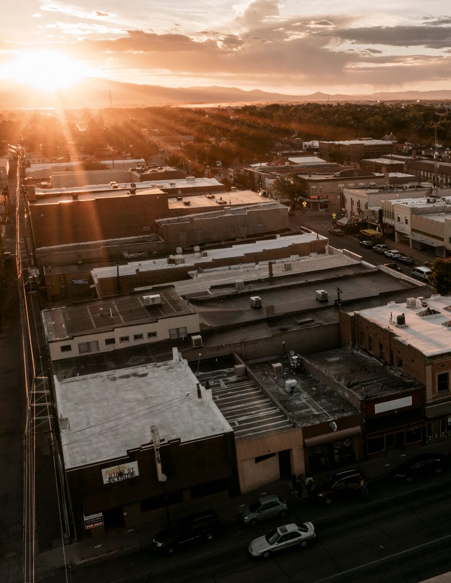 ALAMOSA, CO - SEPT. 15, 2021 - Mount Blanca and the Sangre de Cristo mountain range rise above the San Luis Valley as evening traffic rolls through downtown Alamosa.