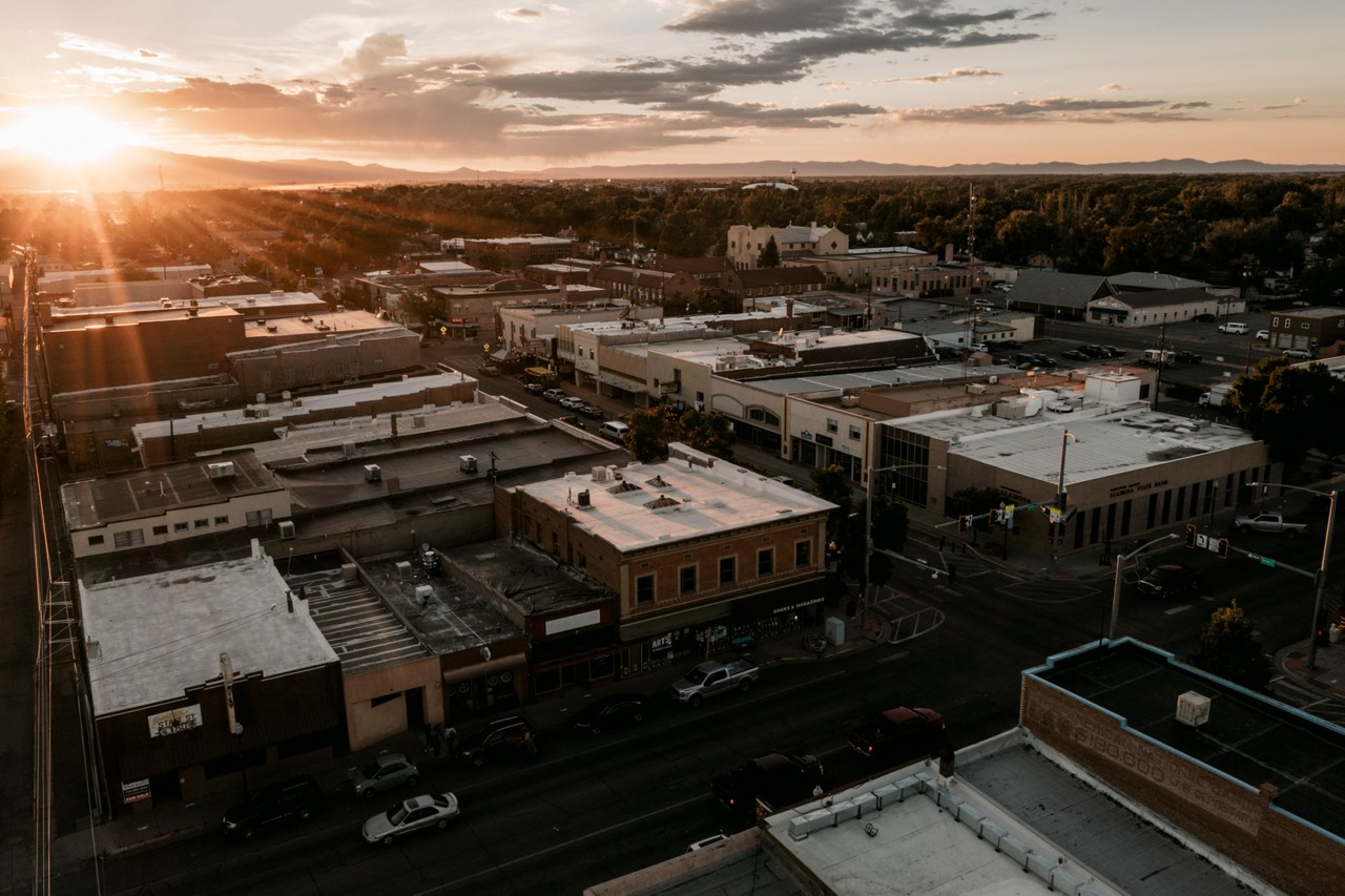 ALAMOSA, CO - SEPT. 15, 2021 - Mount Blanca and the Sangre de Cristo mountain range rise above the San Luis Valley as evening traffic rolls through downtown Alamosa.