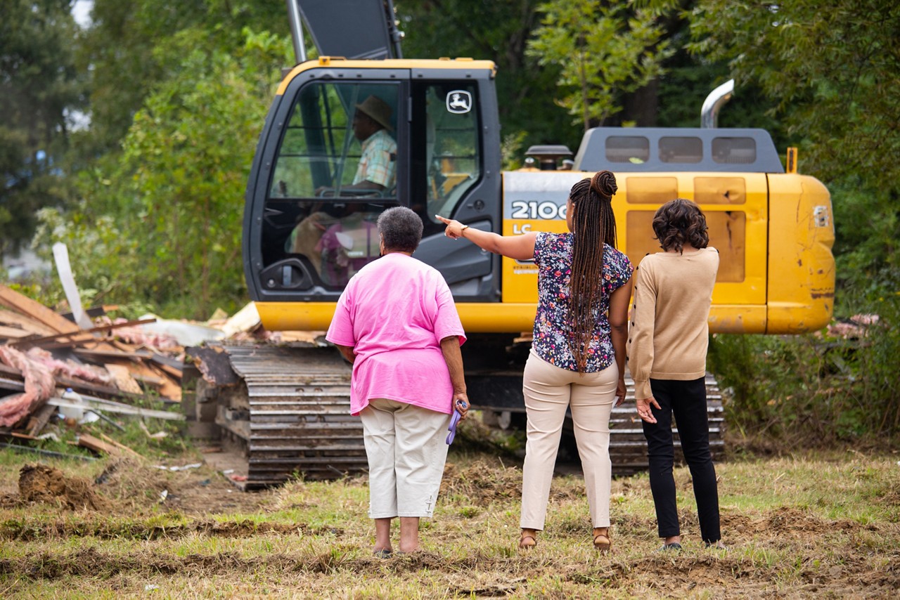 Mary Phillips, Tierra Fountain and Gloria Dickerson watch the demolition of an abandoned home in Drew, Mississippi.  Demolishing abandoned homes is part of a larger effort to build pathways to home ownership with affordable housing and improving the physical environment in Drew.