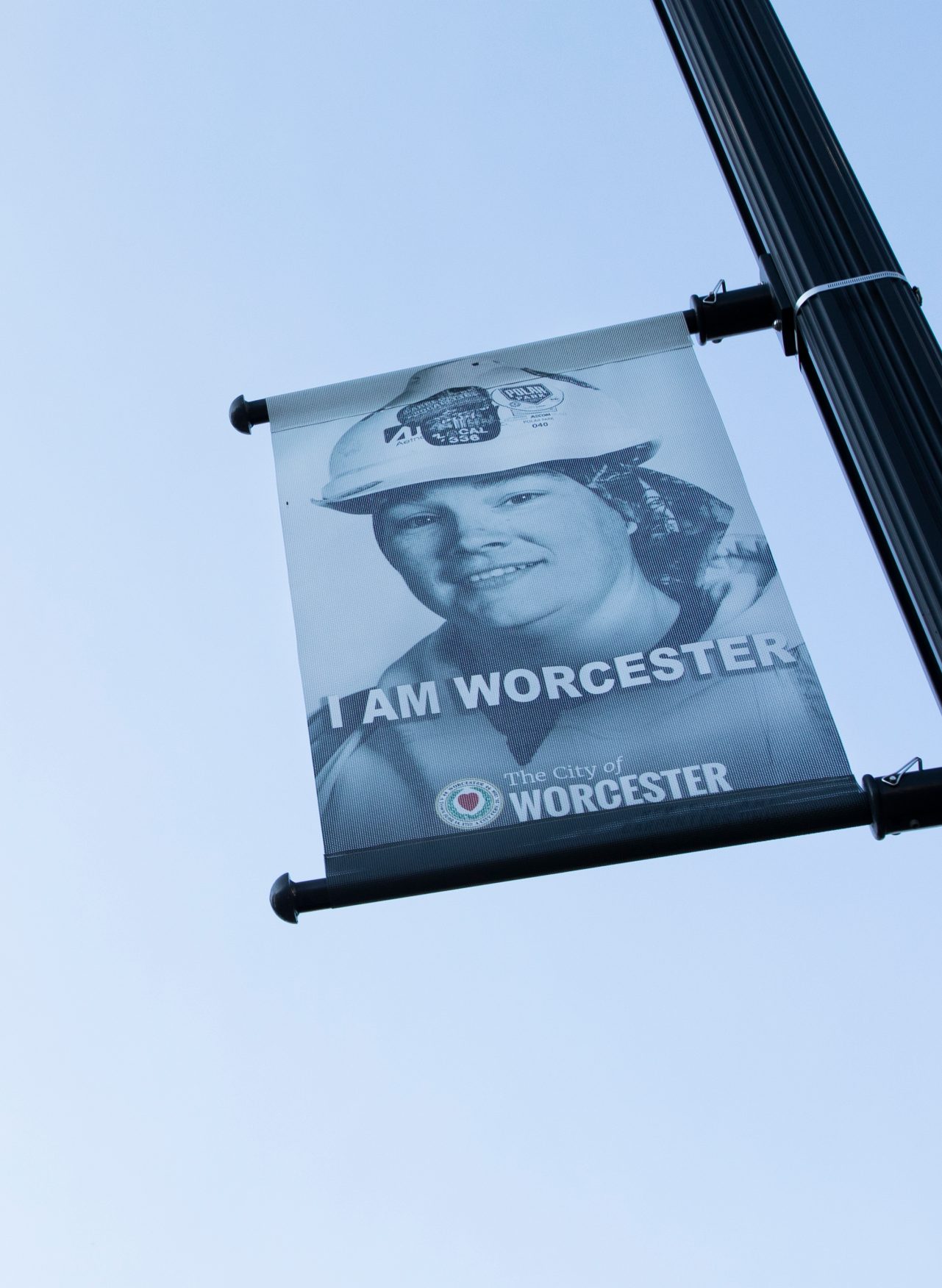 A banner hanging on a solar streetlight.