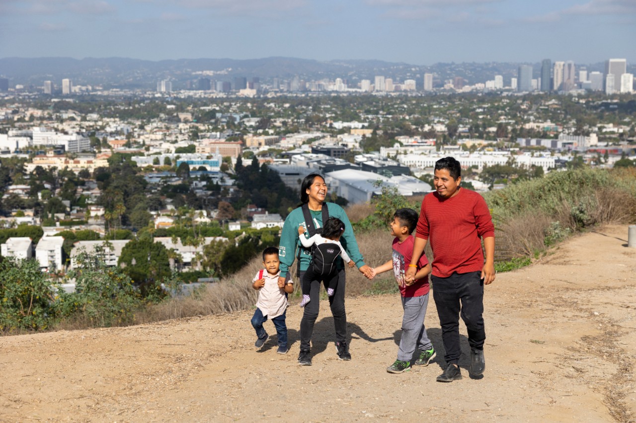 A family of five with three young children hike the Baldwin Hills Scenic Overlook Trail in Los Angeles, California.