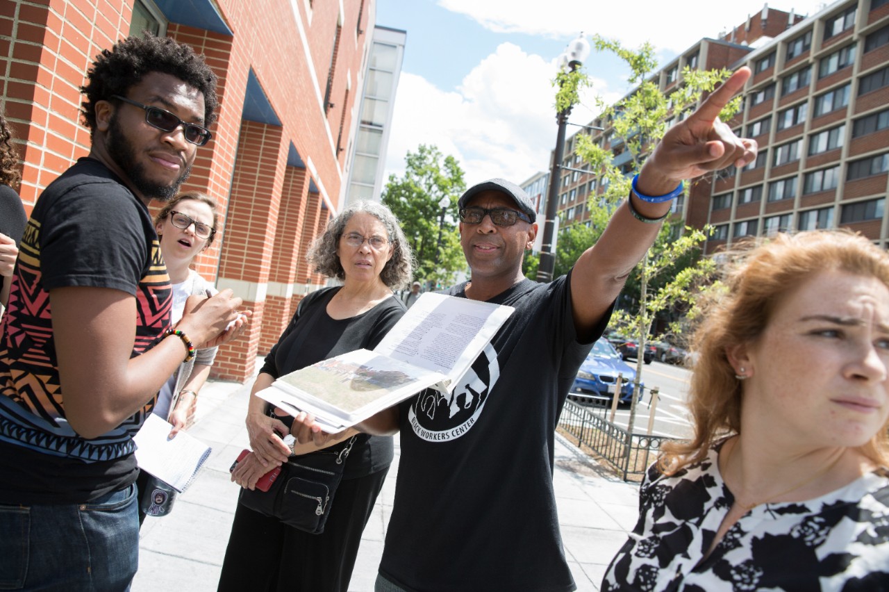 Community organizers talk while touring a neighborhood.