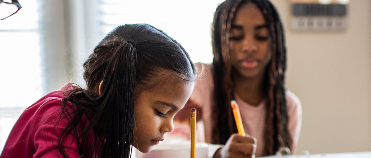 Father working from home while daughters homeschool