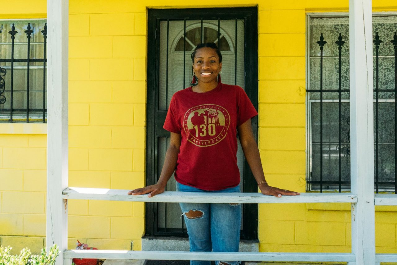 Jasmyne Reese, neighborhood coordinator, in front of her grandmother's house. The house was built in 1965 and her grandmother still resides there.