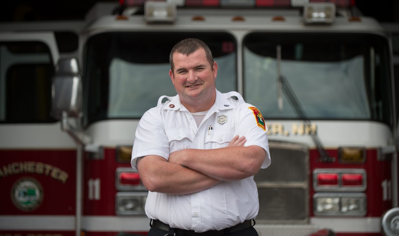 Firefighter Christopher Hickey stands in front of Central Fire Station in Manchester, N.H. on Thursday, Aug. 18, 2016.