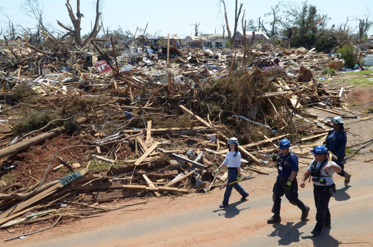 TUSCALOOSA, ALABAMA - MAY 06, 2011: Members of a search and recovery team, made up of firefighters and rescue personnel from Louisiana and Alabama, search tornado devastated areas in Tuscaloosa. Many people lost everything when their homes were destroyed by a powerful tornado that hit Tuscaloosa, Alabama.