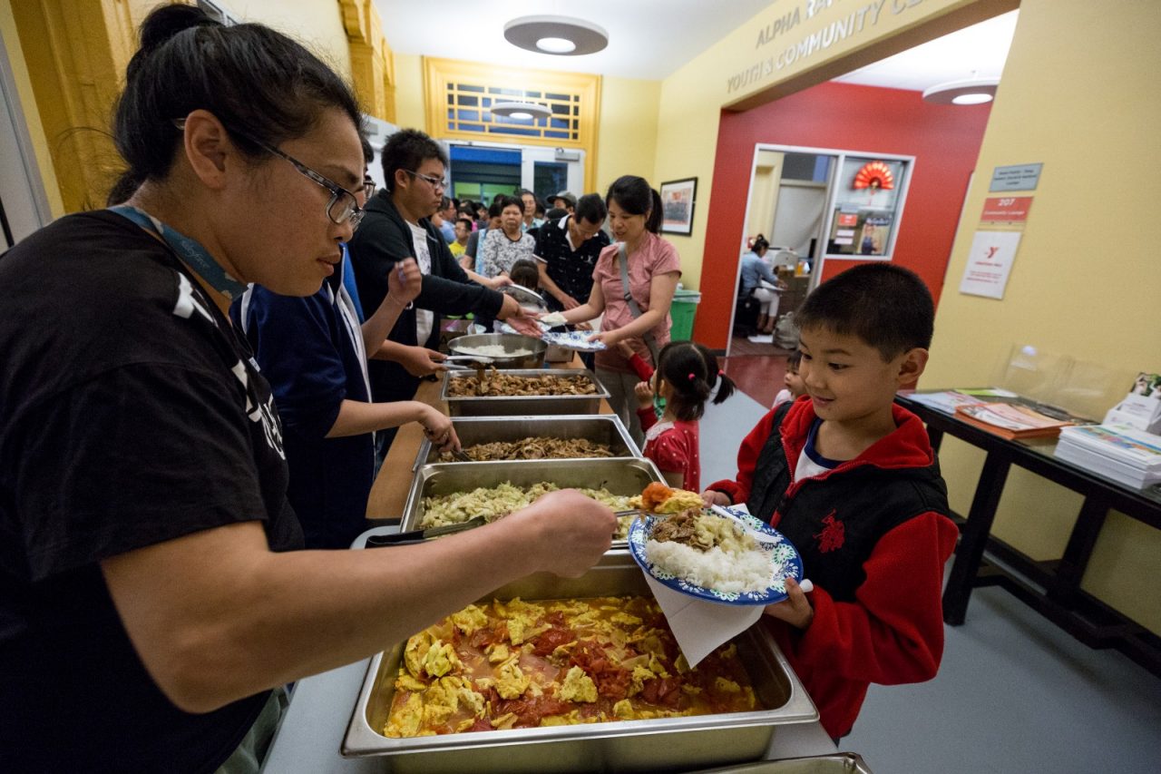Serving food for the Thursday night dinner at the San Francisco Chinatown YMCA.