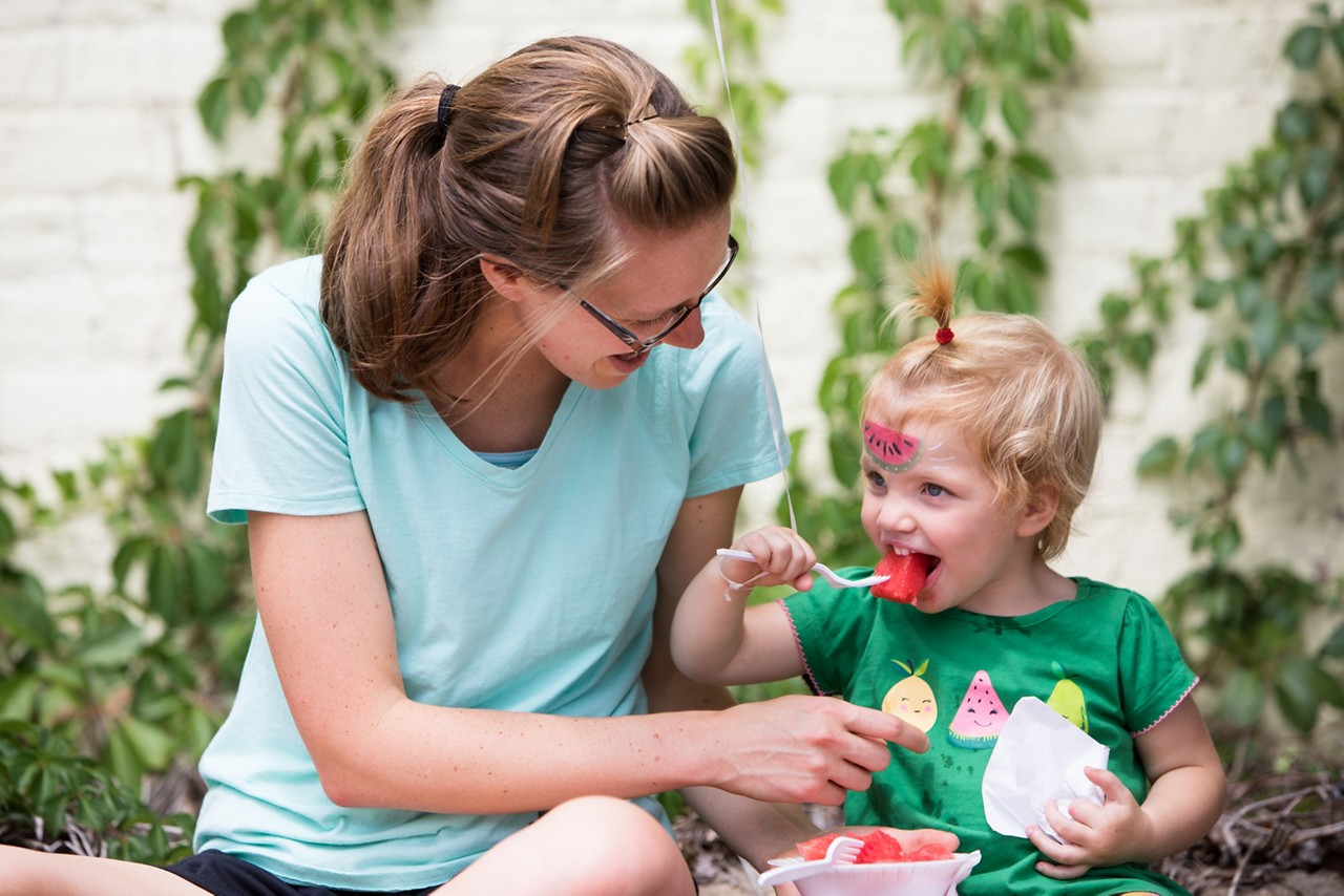 Richmond, VA COH 2017. Alice (mom) and Arya Maley (kid) enjoy fresh fruit at the Carytown Watermelon Festival. Each year the Shriners sell watermelons donated by Publix Super Markets with the proceeds benefiting the Shriners Hospital for children. This is the only multi-hospital pediatric system in the United States that provides care and services to children free of charge. The Shriners Hospitals for children are currently treating hundreds of children from the Richmond area.