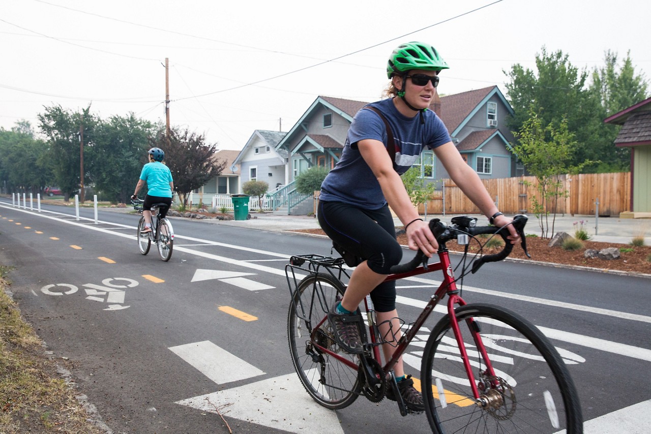 Jennifer Little, Co-chair of the Healthy Klamath Coalition and supervisor of Sky Lakes Outpatient Care Management, rides on the protected bike lane in downtown Klamath Falls, Oregon.