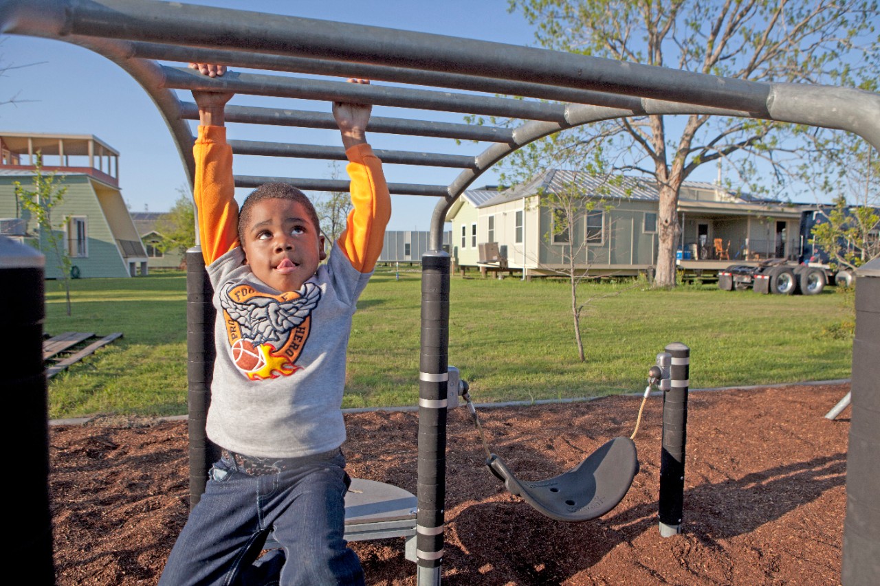 Children and families playing at a newly built park in the midst of rebuilt houses in the Lower Ninth Ward, one of the areas most affected by Hurricane Katrina.