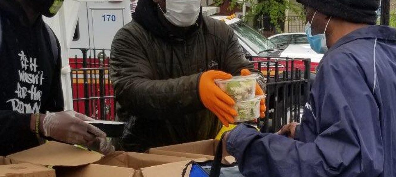 Men distribute food. Bronx, NY