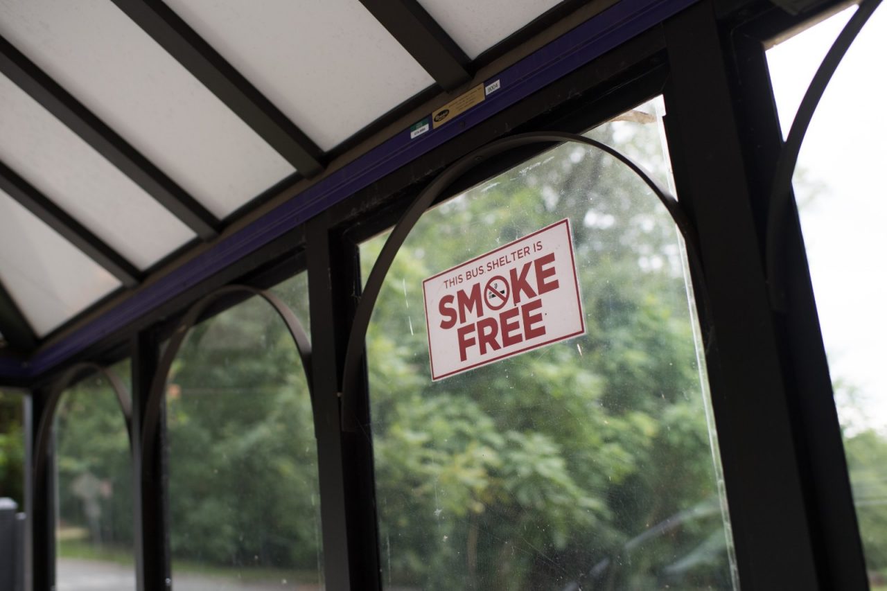 Smoke free signage is on display at a bustop in Nicholtown, a neighborhood just outside of downtown Greenville.
