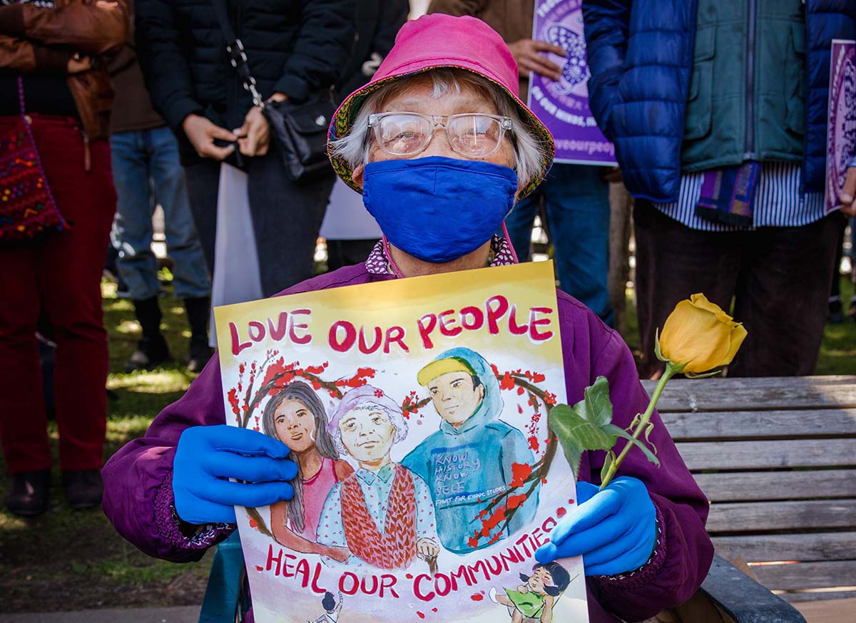 Woman holding poster.