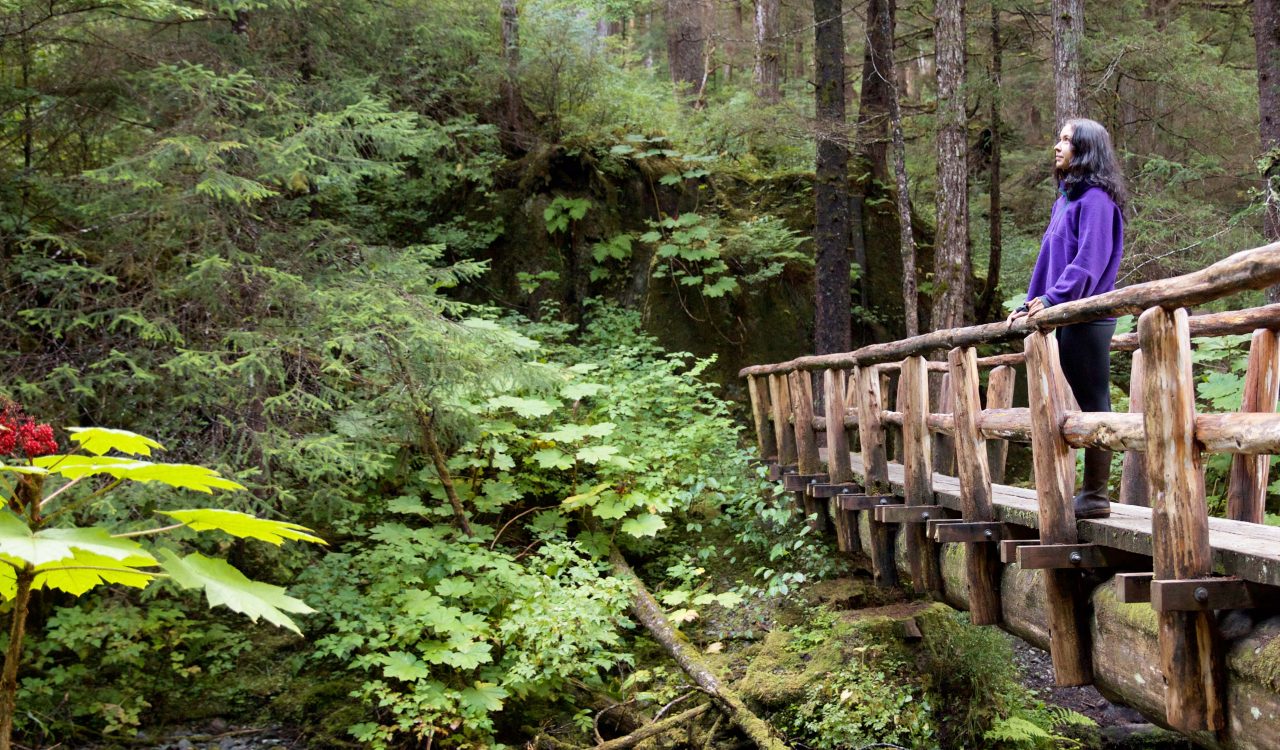 SITKA, ALASKA - SEPTEMBER 2019: Meaghan M. Way walking the Herring Cove trail in Sitka, Alaska.