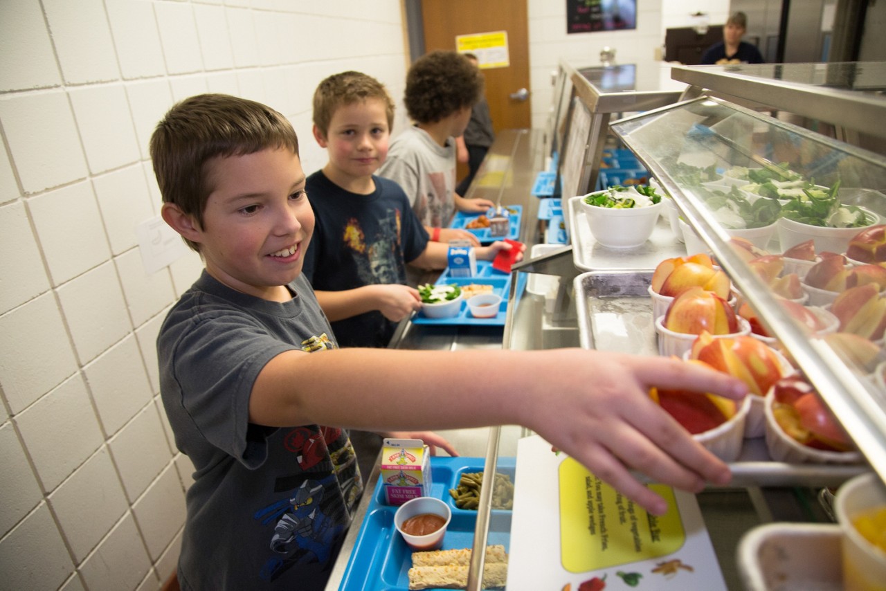 Signs of Progress: Nebraska. Children exercise during PE class and eat a healthy snacks at Fredstrom Elementary in Lincoln, NE. Children can also be seen touring the schools kitchen.