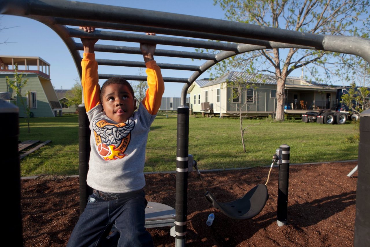 Children and families playing at a newly built park in the midst of rebuilt houses in the Lower Ninth Ward, one of the areas most affected by Hurricane Katrina.

