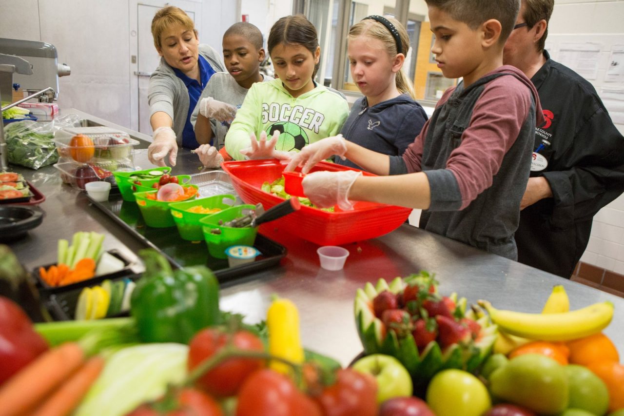 Children enjoy preparing a healthy snack of fruits and vegetables.