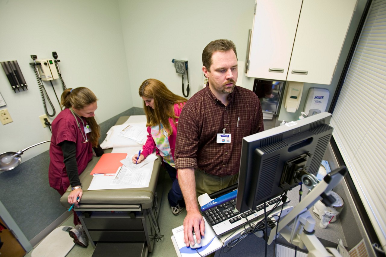 Doctor Devin Sawyer makes his rounds at St. Peter Family Practice, Olympia, Washington. Shari Gioimo, CMA, and another nurse in the background. Improving Chronic Illness Care.