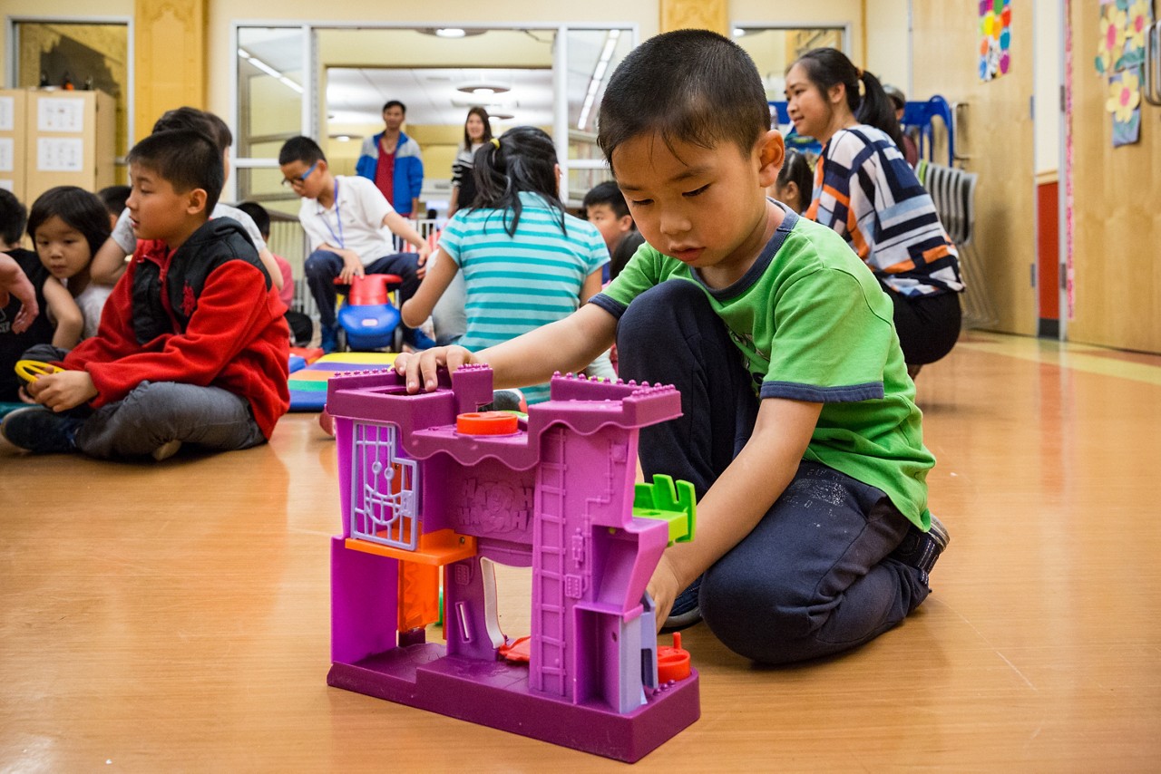 Children from SRO families play at the San Francisco Chinatown YMCA while the adults prepare the dining room for the Thursday night dinner.