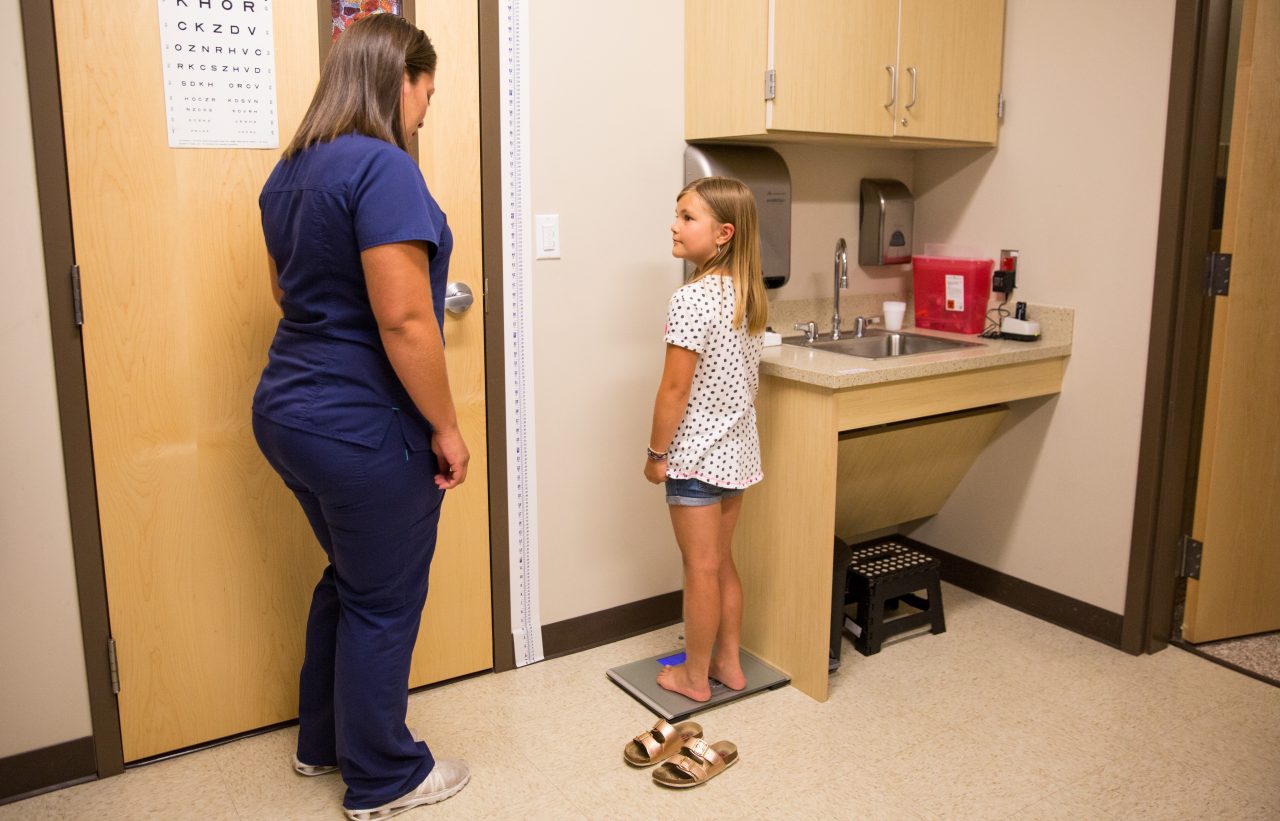 Nurse Melanie Hernandez weighs 8 year old patient Ryden Hofer during a checkup at the School Based Health Center at Lake County High School in Leadville, Colorado. The School Based Health Center provides medical care and mental health services to students, teachers and families in the district.