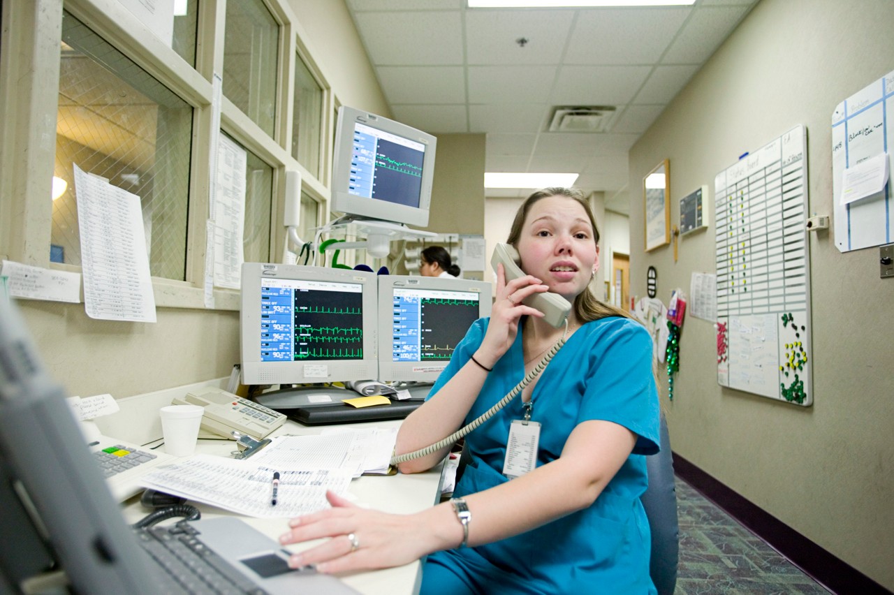 Nichole Hoppe, registered nurse in blue scrubs, staffs the nursing station at medical surgical floor of Seton Northwest Hospital, Austin, Texas. Transforming Care at the Bedside.8/1/16 - MP confirmed rights and hi-res dimensions in Gaggle; http://gaggle.rwjf.org/assets-search?term=11576. 