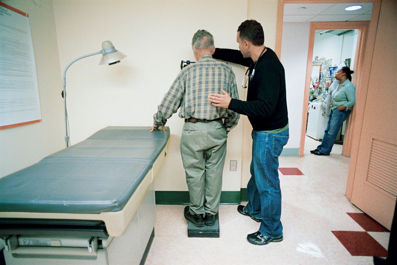 Mark Ragner, MD, weighs a patient in St. Vincent's Hospital, New York, NY. 2007 Annual Report