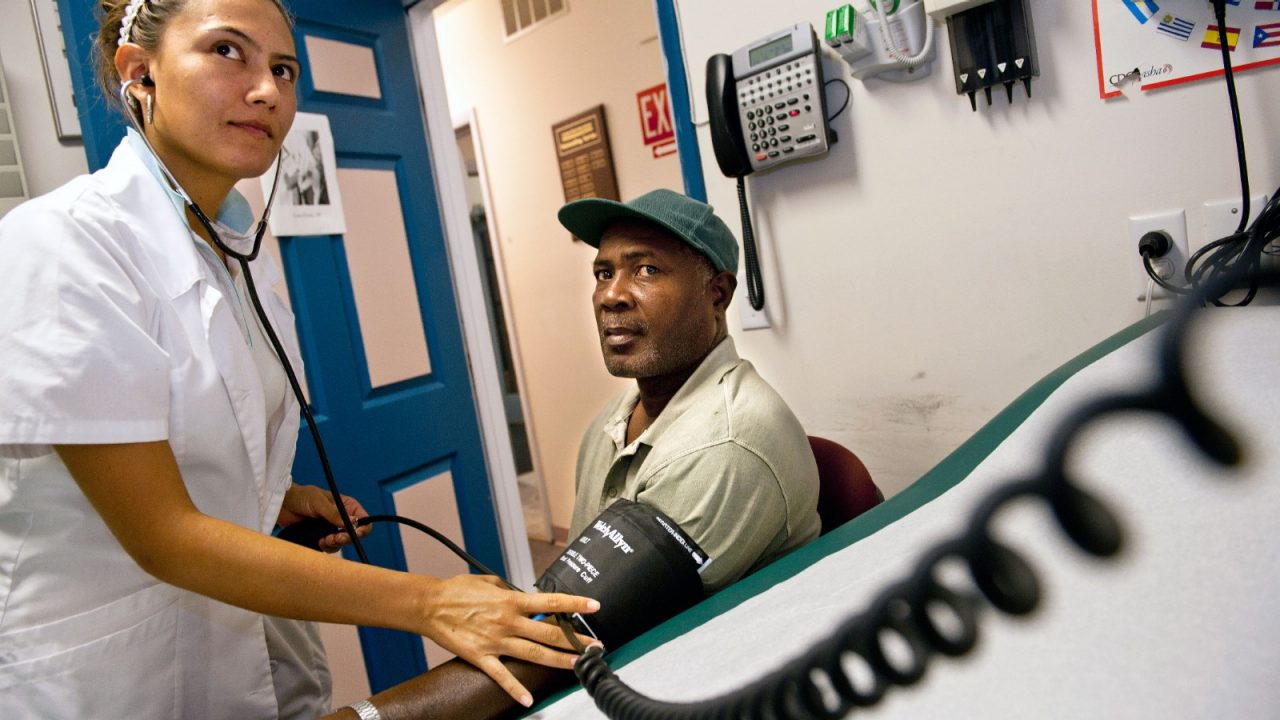 A nurse takes a man's blood pressure at a health fair.