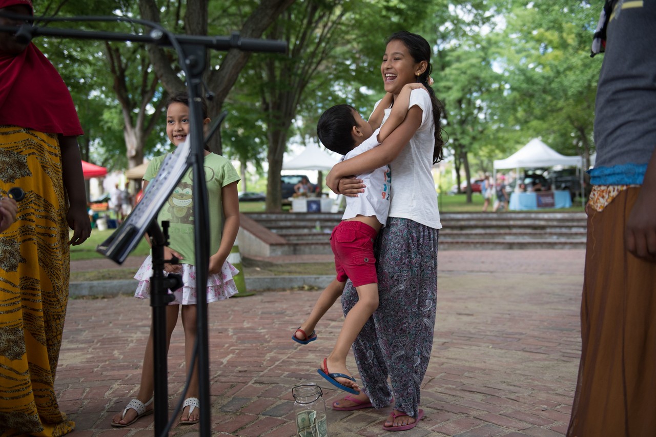 Children listen to free music in Victory Park in Manchester, N.H. on Thursday, Aug. 18, 2016.