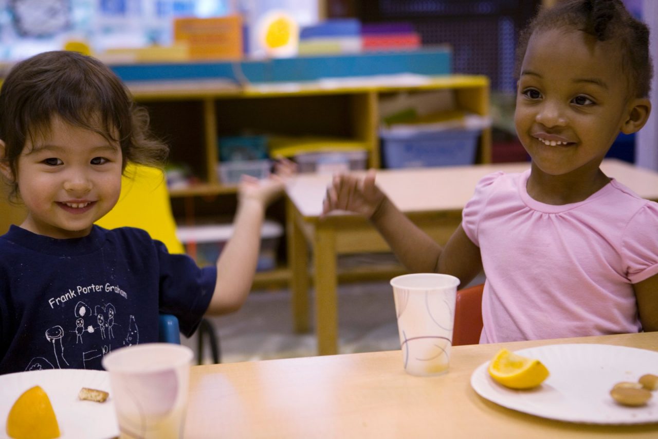 Nariya Farrington and classmate eating a healthy snack at school. Frank Porter Graham Child Development Center in Chapel Hill, North Carolina.