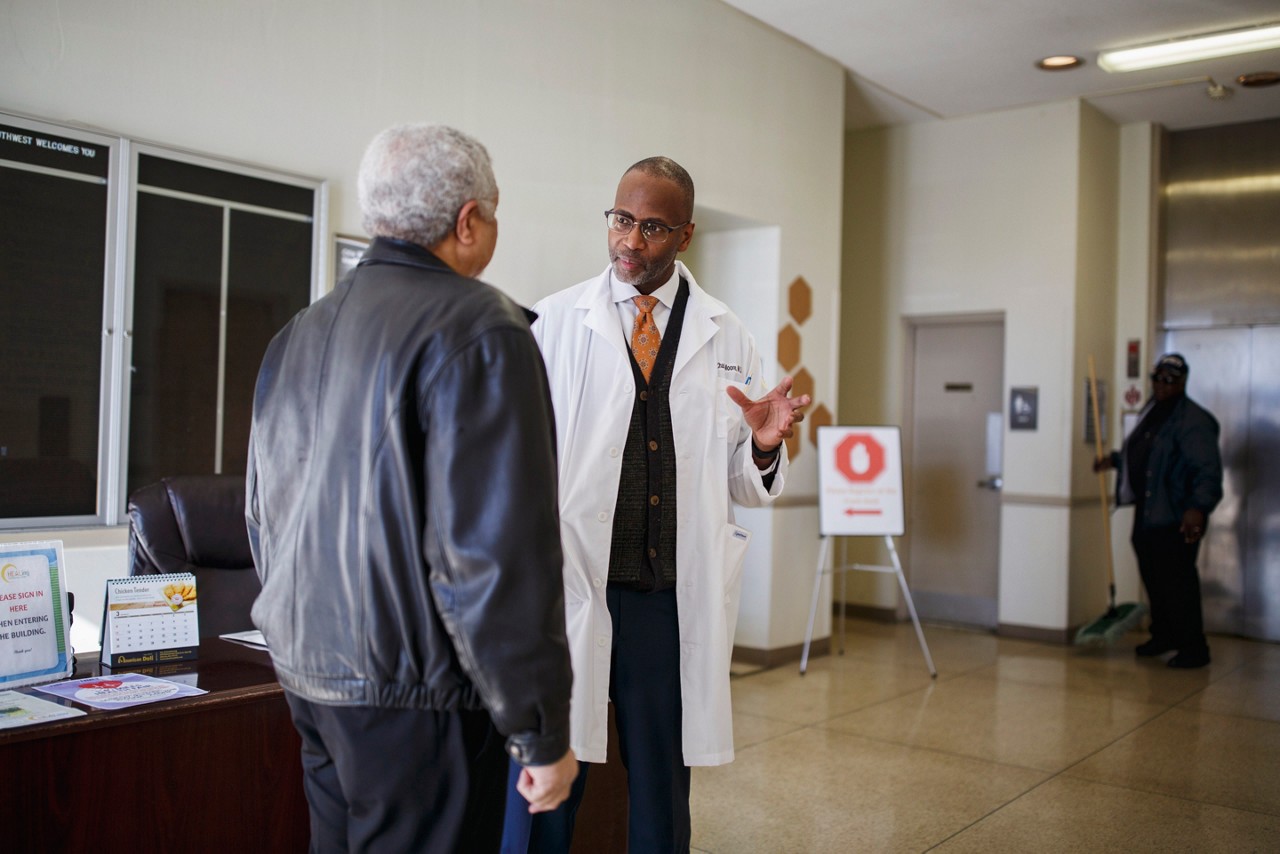 Two doctors talking with a patient. Two doctors talking with a patient.