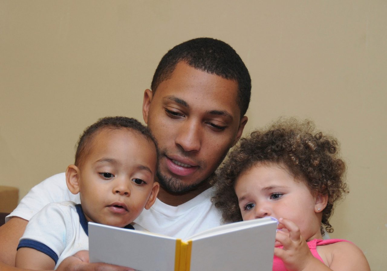 Family Reading. Two Generation Family Reading Father Son Niece