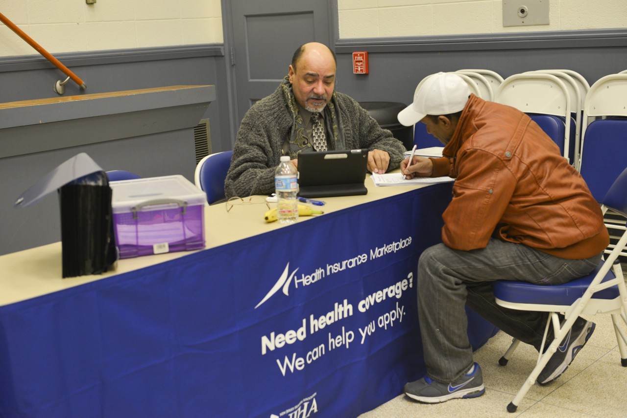 Two men discussing insurance forms.