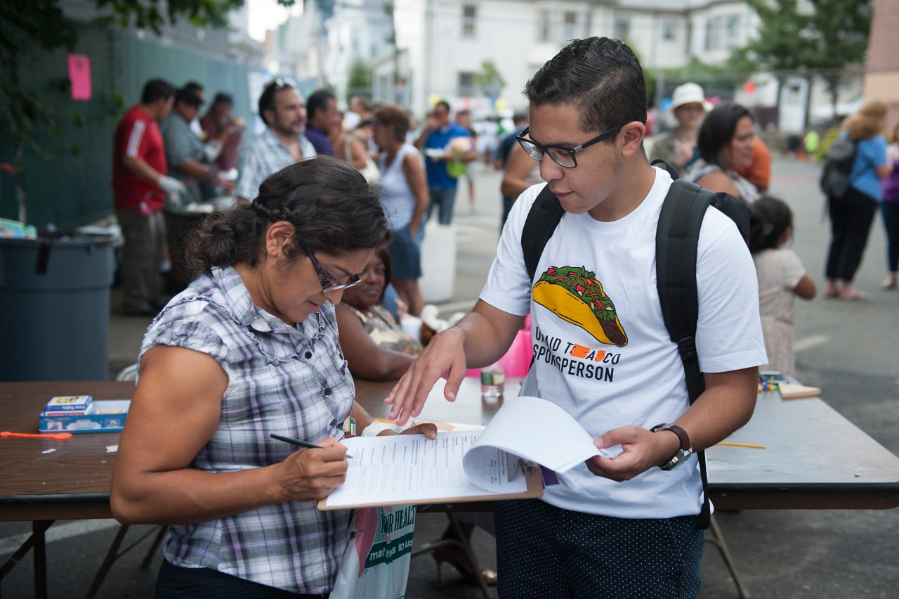 Gustavo Castilho, a member of Teens in Everett Against Substance Abuse, surveys one of the guests at the One Everett block party.