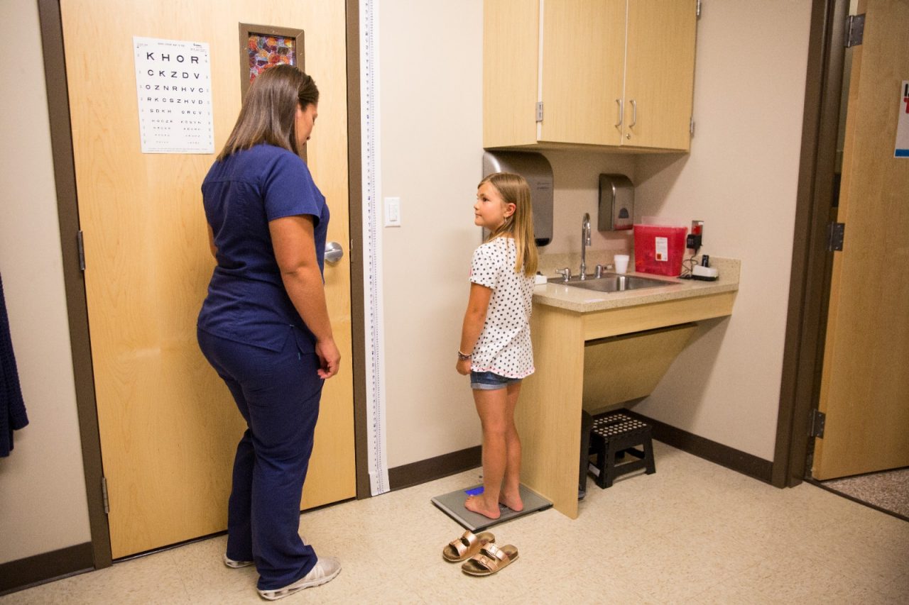 Nurse Melanie Hernandez weighs 8 year old patient Ryden Hofer during a checkup at the School Based Health Center at Lake County High School in Leadville, Colorado. The School Based Health Center provides medical care and mental health services to students, teachers and families in the district.