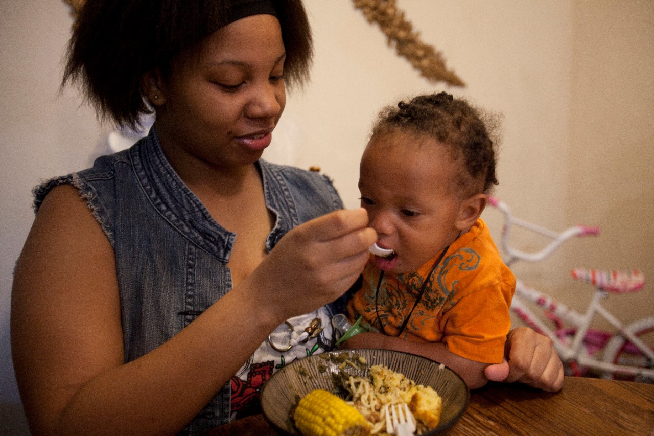 Woman feeding baby. Residents of the Columbia Parc community, a mixed-income residential community built where the St. Bernard Housing Project stood. The latter was flooded badly by Hurricane Katrina, and demolished.
Catania Marie Jones, in red shirt, with daughters.