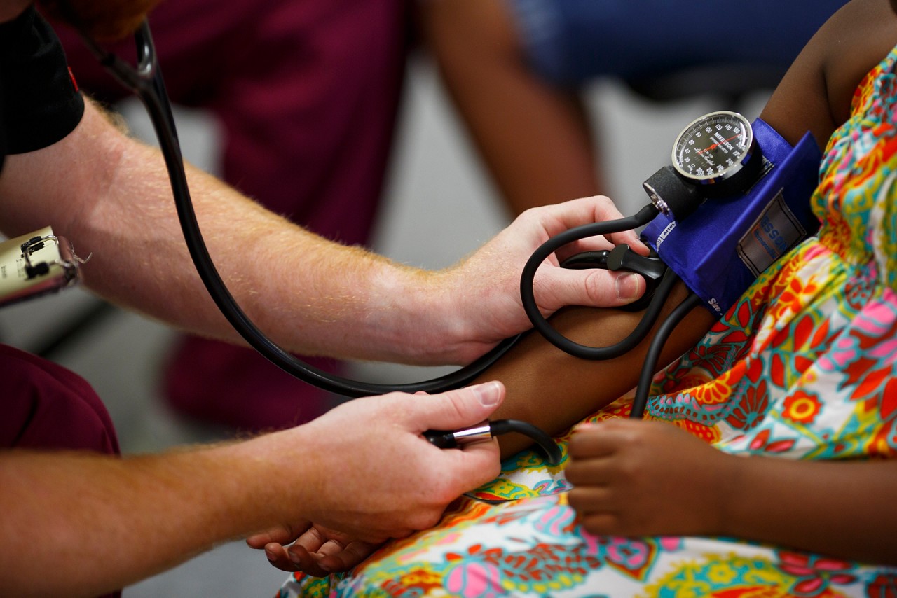 A young girl has her blood pressure tested during health screenings at the ReGenesis Back to School Fair in Spartanburg, SC.