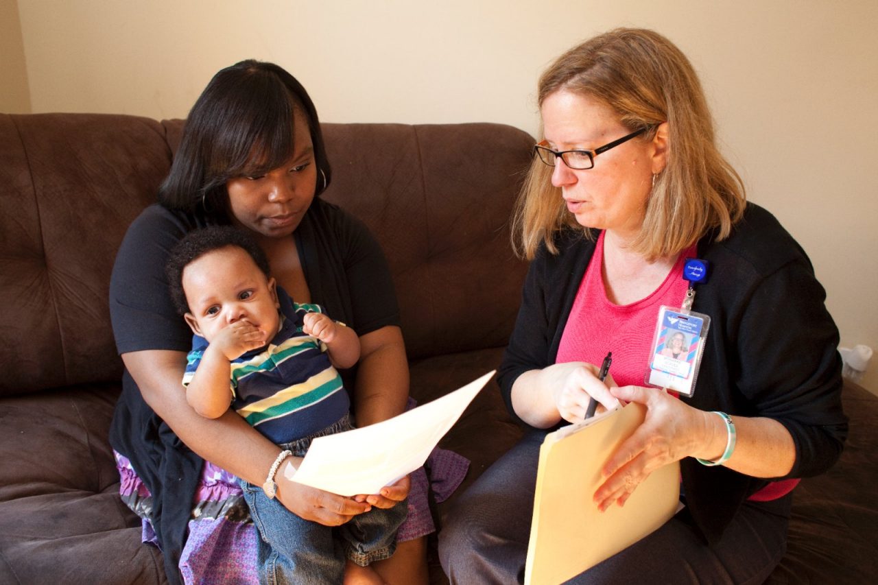 Jeanette Sorrells, mom and baby Samir Johnson, with Child First team member Monarae Scales. Child First program care coordinators and clinicians meet with families in Norwalk, CT