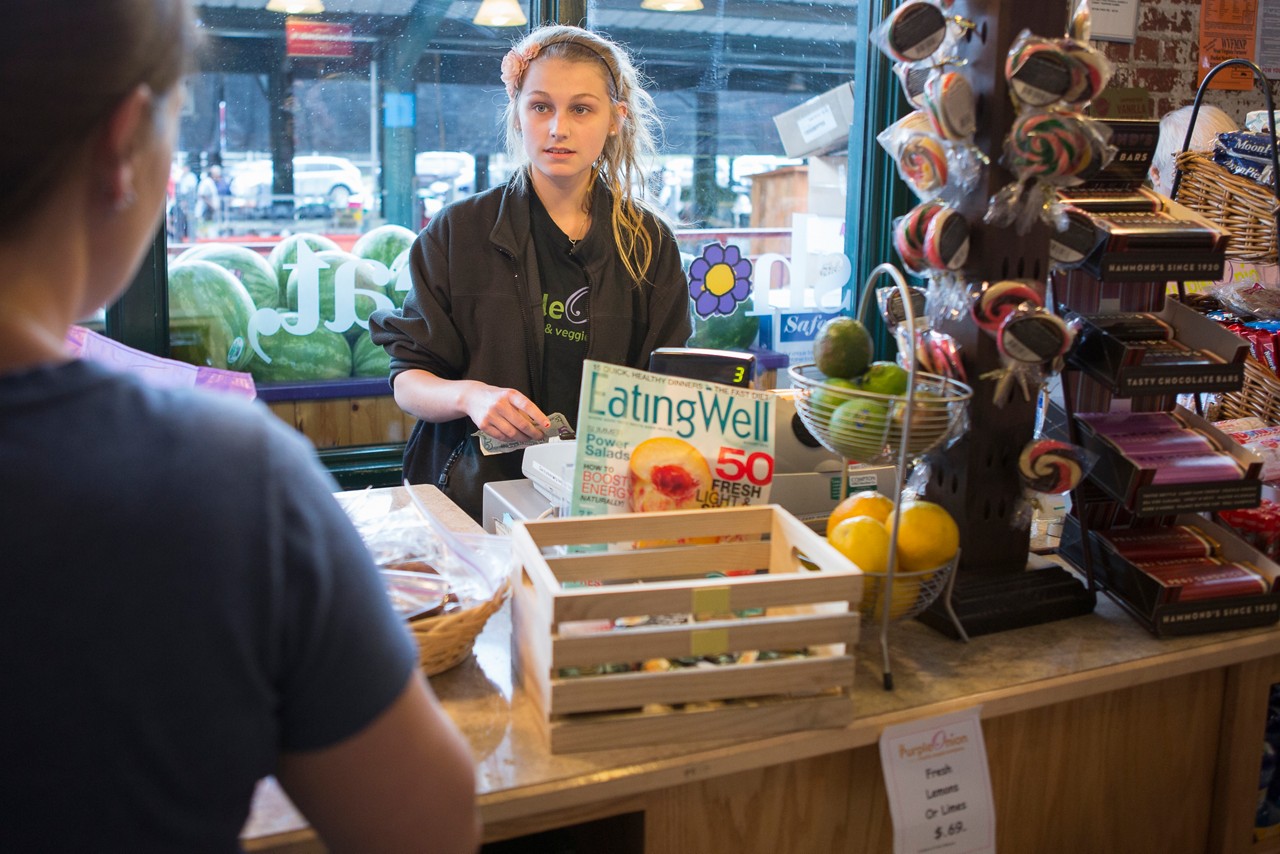 A teenager works behind a counter in a country store. Rural health