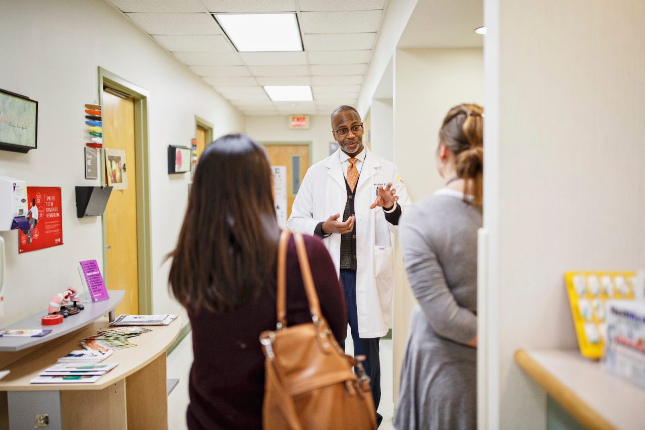 A doctor giving a tour of a medical facility. 
