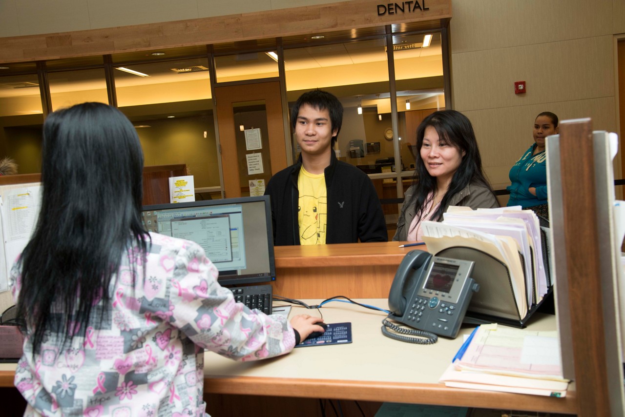 A mad and women at an office reception. desk