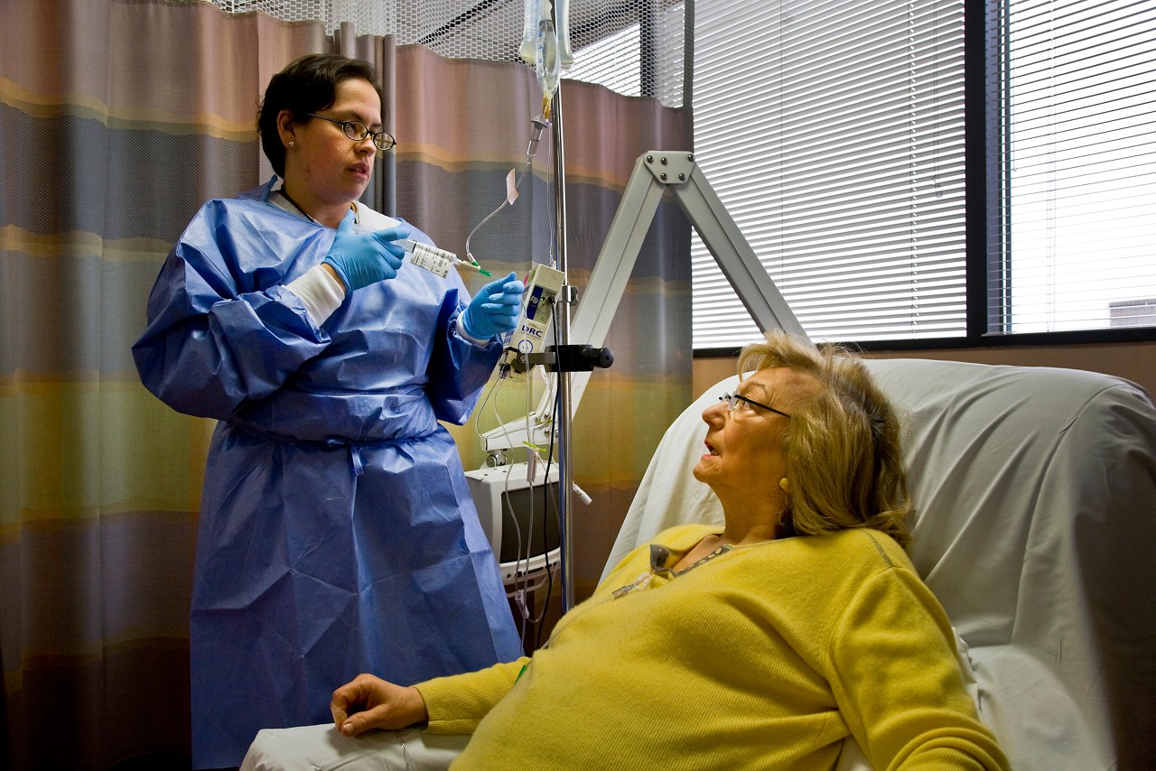 A nurse with a cancer patient who is receiving chemo therapy.